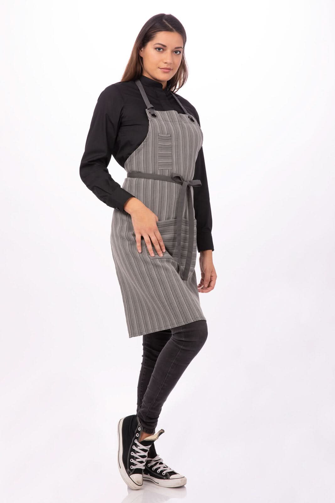 Dark grey Chef Works Brooklyn Bib Apron for chefs, featuring adjustable neck strap and front pockets, part of professional chef uniforms.