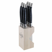 Set of six Andre Verdier Laguiole Debutant Omnicoleur black steak knives in a wooden block, featuring sleek handles and sharp blades.
