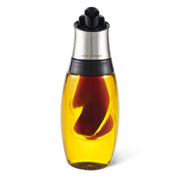 Cole & Mason Oil & Vinegar Duo Pourer paired with salt and pepper shakers on a kitchen countertop.